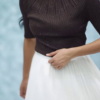 1164-4.png Women’s Pink Ribbed Half-Sleeve Top with Black Pleated Mini Skirt – Chic Contrast Casualwear Ensemble