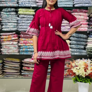1187-1.png Women’s Red Embroidered Kurti Pant Set – White Threadwork Details with Boutique Shelf Backdrop
