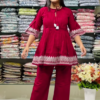 Women’s Red Embroidered Kurti Pant Set – White Threadwork Details with Boutique Shelf Backdrop
