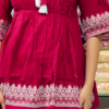 Women’s Red Embroidered Kurti Pant Set – White Threadwork Details with Boutique Shelf Backdrop
