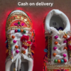 1197-1.png Unisex White Ethnic Mojari Footwear with Multicolor Bead Embroidery – Festive Pair with Red Light Showcase Styling