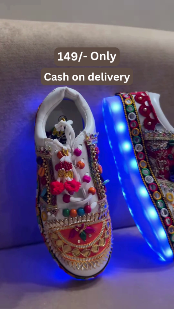 1197-2.png Unisex White Ethnic Mojari Footwear with Multicolor Bead Embroidery – Festive Pair with Red Light Showcase Styling