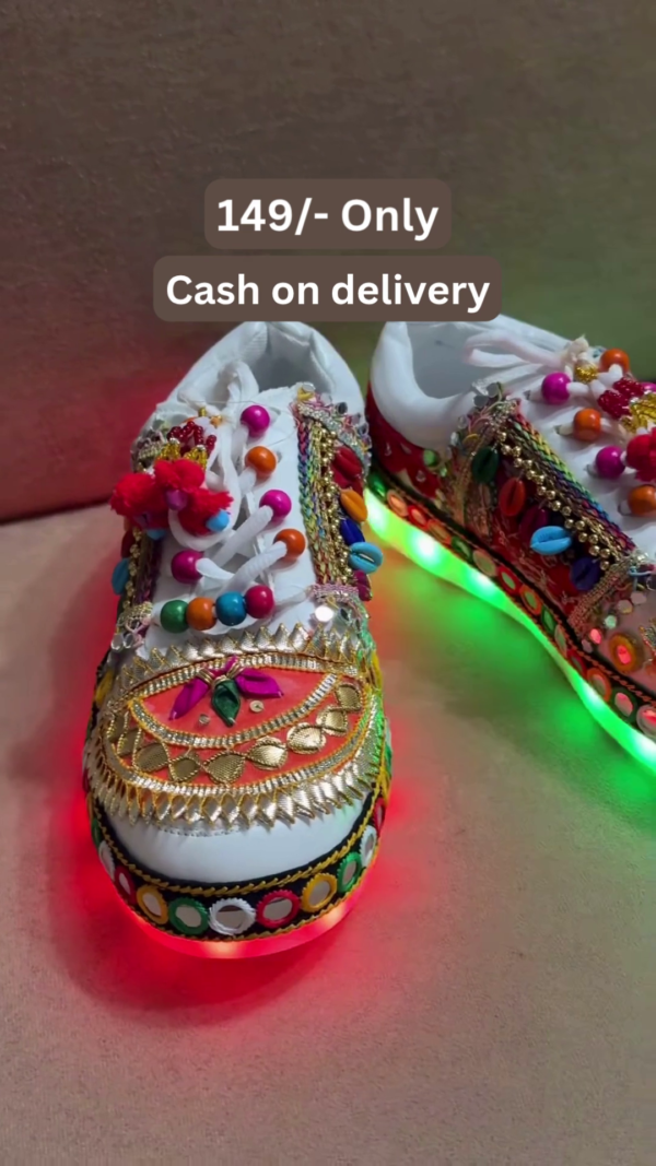 1197-5.png Unisex White Ethnic Mojari Footwear with Multicolor Bead Embroidery – Festive Pair with Red Light Showcase Styling