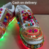 1197-6.png Unisex White Ethnic Mojari Footwear with Multicolor Bead Embroidery – Festive Pair with Red Light Showcase Styling