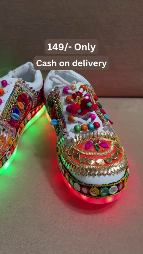 1197-6.png Unisex White Ethnic Mojari Footwear with Multicolor Bead Embroidery – Festive Pair with Red Light Showcase Styling