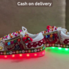1197-7.png Unisex White Ethnic Mojari Footwear with Multicolor Bead Embroidery – Festive Pair with Red Light Showcase Styling