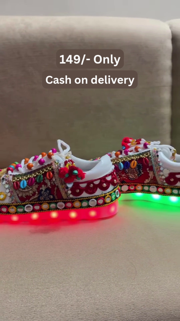 1197-7.png Unisex White Ethnic Mojari Footwear with Multicolor Bead Embroidery – Festive Pair with Red Light Showcase Styling