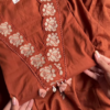 Women’s Reddish-Brown Ethnic Kurti with Floral Embroidery, Tassels & Shell Accents – Handcrafted Neckline Detailing for Festive Styling