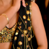 Women’s Black Saree with Gold Embellishments & Pleated Draping – Elegant Ethnicwear Styled with Traditional Bracelet