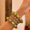 Women’s Black Saree with Gold Embellishments & Pleated Draping – Elegant Ethnicwear Styled with Traditional Bracelet