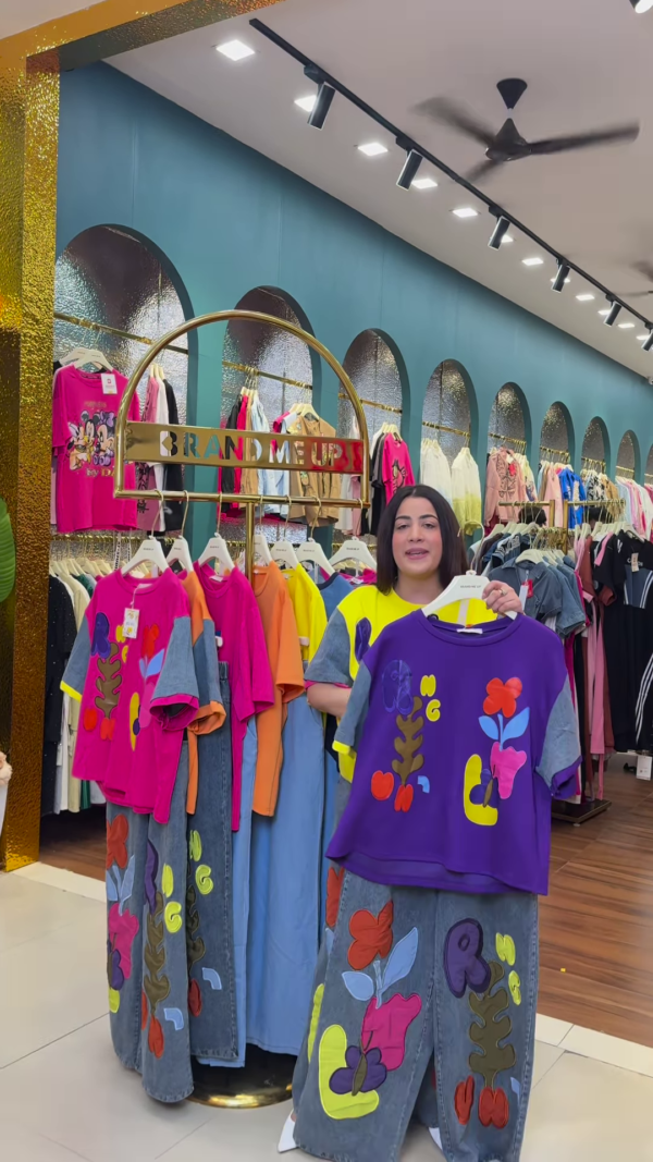 1205-1.png Multicolor Printed Ethnicwear Rack Display – Bold Floral & Abstract Garments in Boutique Interior with Teal-Gold Accents