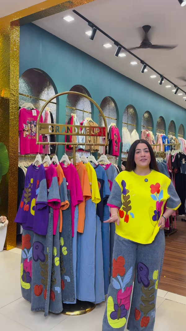 1205-4.png Multicolor Printed Ethnicwear Rack Display – Bold Floral & Abstract Garments in Boutique Interior with Teal-Gold Accents