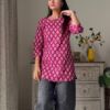 Women’s Sleeveless Red Floral Top with Light Blue Flared Jeans – Indo-Western Casualwear Styled with Vintage Decor Backdrop