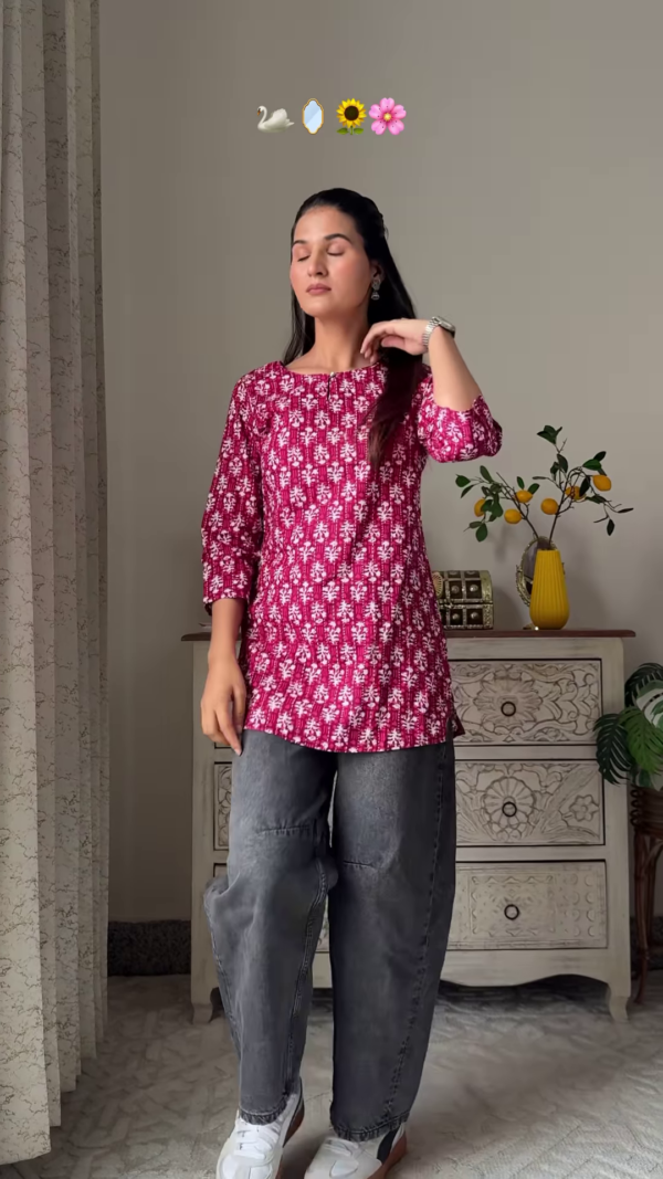 Women’s Sleeveless Red Floral Top with Light Blue Flared Jeans – Indo-Western Casualwear Styled with Vintage Decor Backdrop