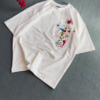1209-1.png Unisex White & Beige T-Shirts with Colorful Paint Splatter and Pocket Embroidery – Artistic Casualwear for Everyday Styling