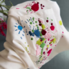 1209-2.png Unisex White & Beige T-Shirts with Colorful Paint Splatter and Pocket Embroidery – Artistic Casualwear for Everyday Styling