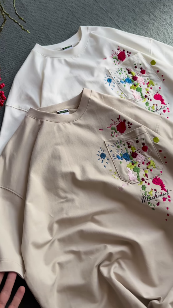 1209-4.png Unisex White & Beige T-Shirts with Colorful Paint Splatter and Pocket Embroidery – Artistic Casualwear for Everyday Styling