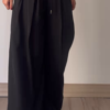 Women’s Beige Wide-Leg Pleated Pants with Drawstring Waist – Flowing Casualwear Styled with White Sneakers
